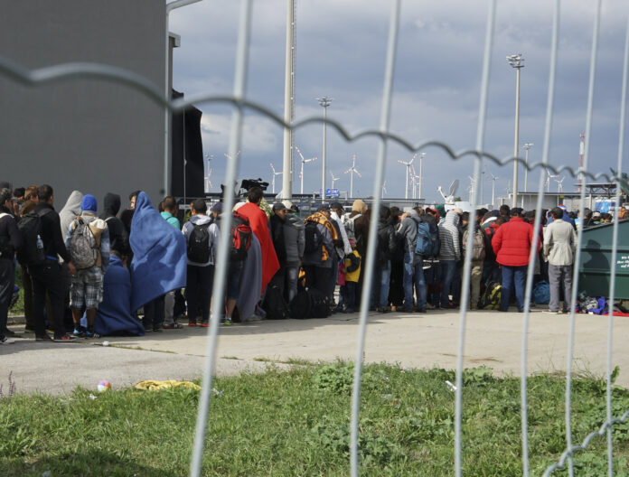a_line_of_syrian_refugees_crossing_the_border_of_hungary_and_austria_on_their_way_to_germany._hungary_central_europe_6_september_2015.jpg