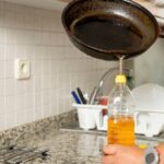 Man,Placing,Recycled,Edible,Oil,From,A,Frying,Pan,Into