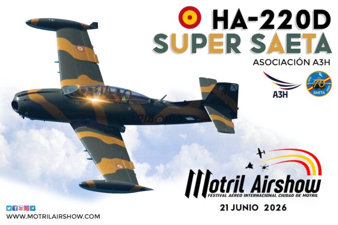 Camouflaged HA-220D Super Saeta aerobatic plane in flight, with Motril Airshow branding and date 21 junio 2026 in the sky.