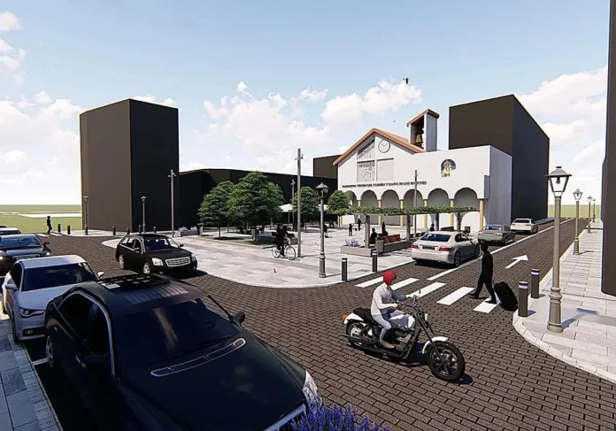 Street scene with cars, a motorcyclist, and a plaza in front of a white arched building under a blue sky.